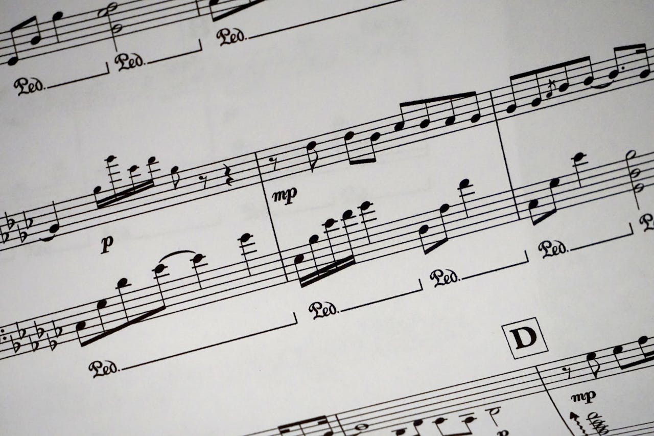 portfolio-05 Close-up of a detailed musical sheet showcasing notes and symbols in black and white.